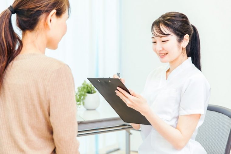 笑顔で問診をとる女性スタッフ