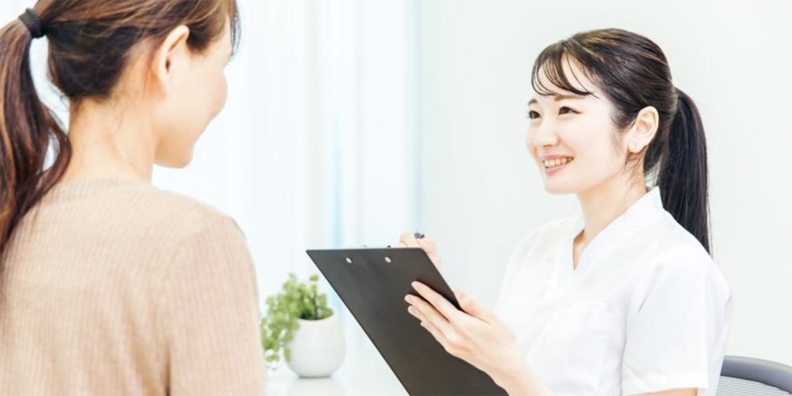 笑顔で問診をとる女性スタッフ